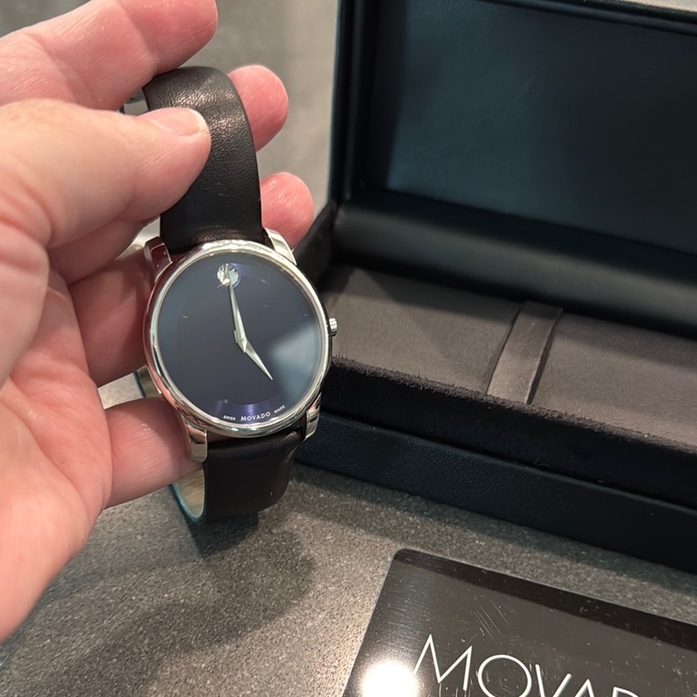 Movado Men’s Silver and Black Watch with Blue face and Leather Band. W/box.